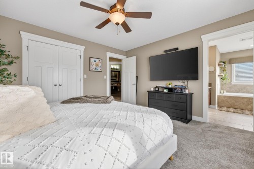 Bedroom featuring a ceiling fan, a closet, and light colored carpet - 21 Dittrich, Fort Saskatchewan, AB - Indoor Photo Showing Bedroom