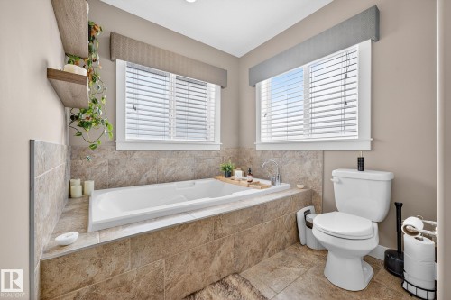 Full bath with a garden tub and toilet - 21 Dittrich, Fort Saskatchewan, AB - Indoor Photo Showing Bathroom