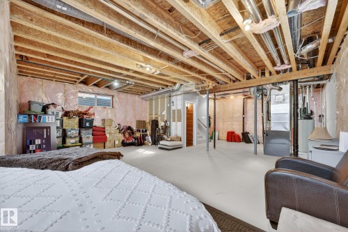 Unfinished below grade area featuring heating unit and water heater - 21 Dittrich, Fort Saskatchewan, AB - Indoor Photo Showing Basement