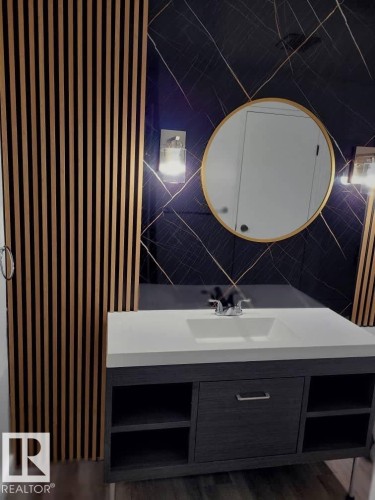 Bathroom with vanity, radiator heating unit, dark wood-style floors, and tile walls - 302 49 Akins Drive, St. Albert, AB - Indoor Photo Showing Bathroom