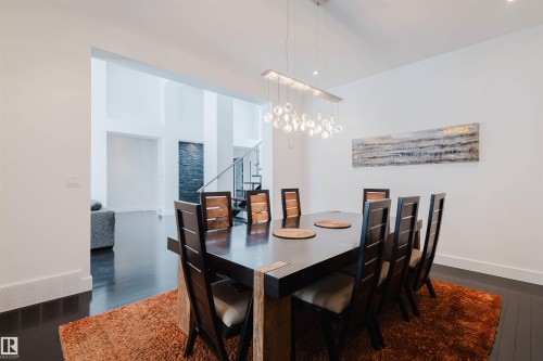 Dining space featuring dark wood-style floors and suspended lighting - 6307 125 Street, Edmonton, AB - Indoor Photo Showing Dining Room