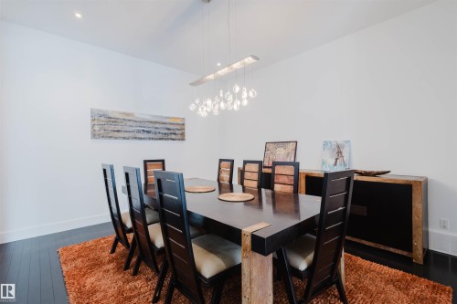 Dining area featuring dark wood-type flooring and hanging lights - 6307 125 Street, Edmonton, AB - Indoor Photo Showing Dining Room