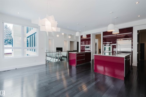 Kitchen with modern cabinets, open shelves, hanging light fixtures, open floor plan, and dark wood finished floors - 6307 125 Street, Edmonton, AB - Indoor