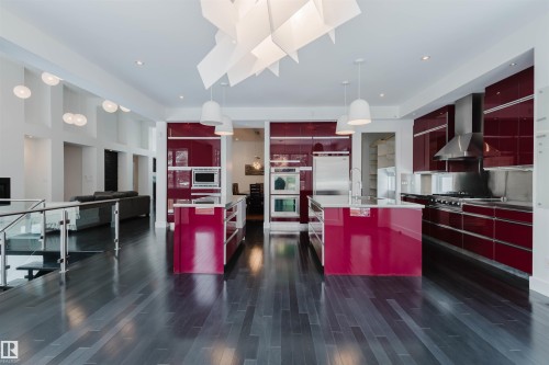 Kitchen featuring modern cabinets, red cabinets, hanging light fixtures, and built in appliances - 6307 125 Street, Edmonton, AB - Indoor Photo Showing Kitchen With Upgraded Kitchen