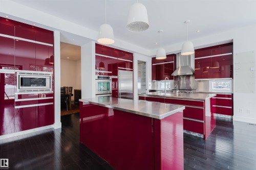 Kitchen featuring stainless steel counters, red cabinets, and modern cabinets - 6307 125 Street, Edmonton, AB - Indoor Photo Showing Kitchen