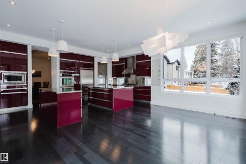 Kitchen with modern cabinets, pendant lighting, built in appliances, and open shelves - 6307 125 Street, Edmonton, AB - Indoor Photo Showing Kitchen