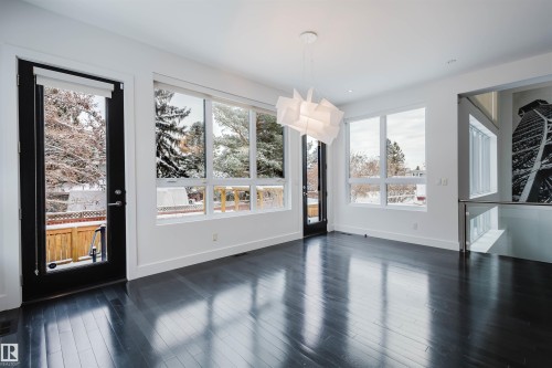 Unfurnished dining area with dark wood finished floors and baseboards - 6307 125 Street, Edmonton, AB - Indoor