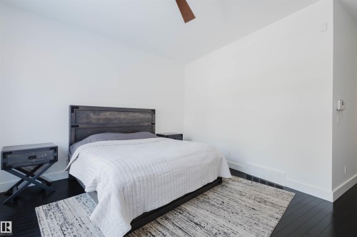 Bedroom featuring dark wood-type flooring, a ceiling fan, and lofted ceiling - 6307 125 Street, Edmonton, AB - Indoor Photo Showing Bedroom