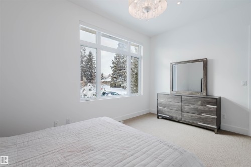 Bedroom with carpet floors and suspended lighting - 6307 125 Street, Edmonton, AB - Indoor Photo Showing Bedroom