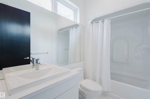 Bathroom with vanity and shower / bath combo with shower curtain - 6307 125 Street, Edmonton, AB - Indoor Photo Showing Bathroom