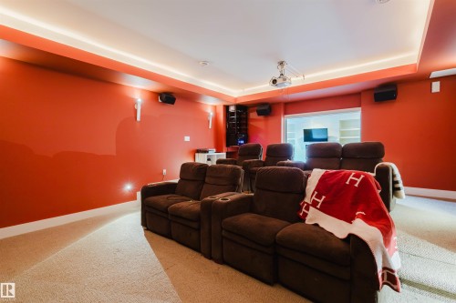Carpeted cinema room featuring a tray ceiling and baseboards - 6307 125 Street, Edmonton, AB - Indoor