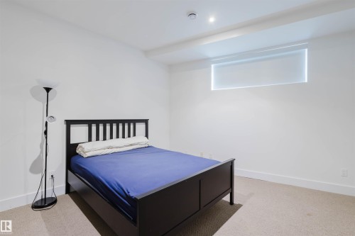 Bedroom featuring baseboards and light colored carpet - 6307 125 Street, Edmonton, AB - Indoor Photo Showing Bedroom