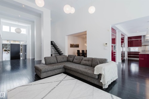 Living area with dark wood-type flooring, a high ceiling, and recessed lighting - 6307 125 Street, Edmonton, AB - Indoor Photo Showing Living Room