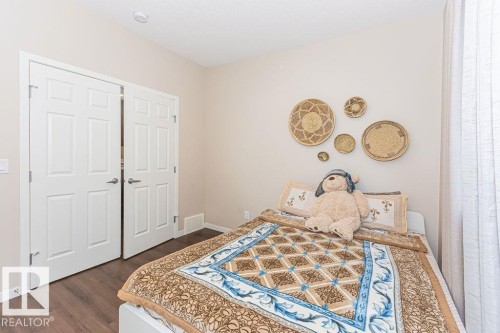 Bedroom featuring dark wood finished floors and baseboards - 3128 13 Avenue, Edmonton, AB - Indoor Photo Showing Bedroom
