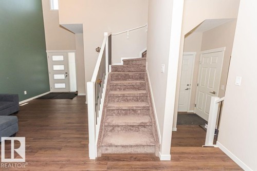 Staircase with a high ceiling and wood finished floors - 3128 13 Avenue, Edmonton, AB - Indoor Photo Showing Other Room