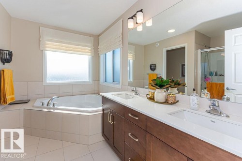 Full bathroom featuring double vanity, a stall shower, a bath, and plenty of natural light - 3128 13 Avenue, Edmonton, AB - Indoor Photo Showing Bathroom