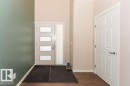 Entryway featuring dark wood-style flooring and baseboards - 3128 13 Avenue, Edmonton, AB  - Indoor Photo Showing Other Room 