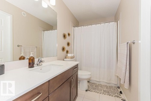 Full bathroom with vanity, light tile patterned floors, and shower / bathtub combination with curtain - 3128 13 Avenue, Edmonton, AB - Indoor Photo Showing Bathroom
