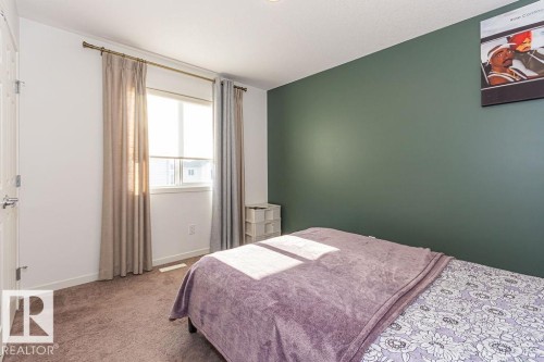Carpeted bedroom featuring baseboards - 3128 13 Avenue, Edmonton, AB - Indoor Photo Showing Bedroom