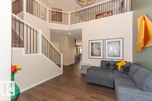 Living area with dark wood-type flooring, a high ceiling, and hanging lights - 3128 13 Avenue, Edmonton, AB - Indoor