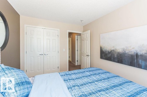 Bedroom featuring a textured ceiling and a closet - 3128 13 Avenue, Edmonton, AB - Indoor Photo Showing Bedroom