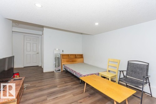 Bedroom with dark wood finished floors, a textured ceiling, and recessed lighting - 3128 13 Avenue, Edmonton, AB - Indoor