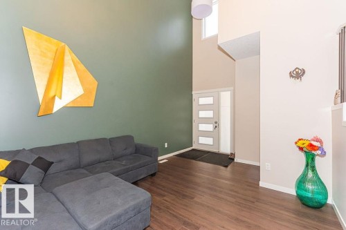 Living area with a high ceiling and dark wood finished floors - 3128 13 Avenue, Edmonton, AB - Indoor Photo Showing Other Room