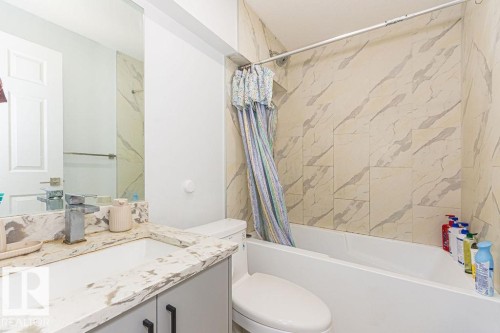 Full bathroom with vanity and shower / bath combo with shower curtain - 3128 13 Avenue, Edmonton, AB - Indoor Photo Showing Bathroom
