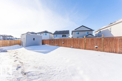 Fenced backyard with a residential view and an outdoor structure - 3128 13 Avenue, Edmonton, AB - Outdoor