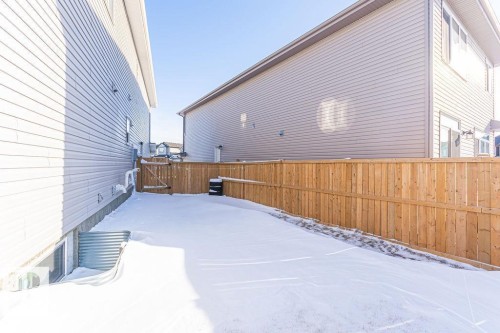 Snow covered property with a fenced backyard and a gate - 3128 13 Avenue, Edmonton, AB - Outdoor With Exterior