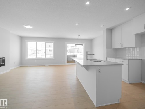 86 Baker Street, Ardrossan, AB - Indoor Photo Showing Kitchen With Fireplace