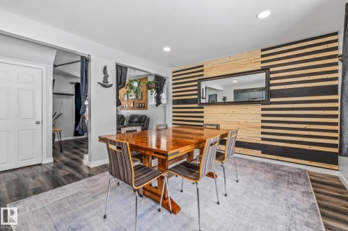 Dining space featuring dark wood finished floors, wood walls, an accent wall, and recessed lighting - 5911 119 Avenue, Edmonton, AB - Indoor Photo Showing Other Room