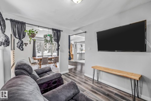 Living room featuring wood finished floors and baseboards - 5911 119 Avenue, Edmonton, AB - Indoor Photo Showing Living Room