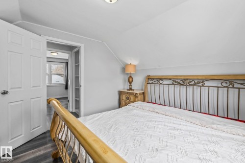 Bedroom with vaulted ceiling and dark wood-style floors - 5911 119 Avenue, Edmonton, AB - Indoor Photo Showing Bedroom