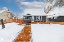 View of front facade with a fenced backyard and a deck - 5911 119 Avenue, Edmonton, AB  - Outdoor With Deck Patio Veranda 