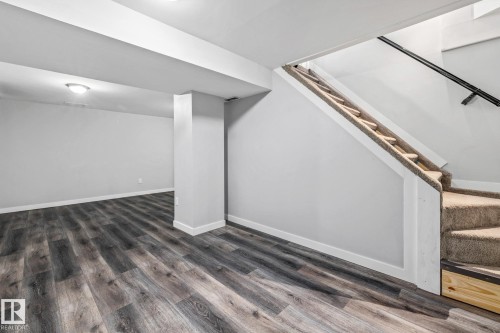 Recreation Room with stairs and dark wood-style flooring - 5911 119 Avenue, Edmonton, AB - Indoor Photo Showing Other Room