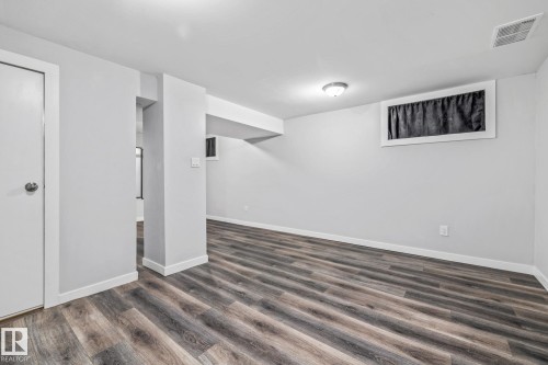 Recreation Room featuring dark wood-style flooring and baseboards - 5911 119 Avenue, Edmonton, AB - Indoor Photo Showing Other Room