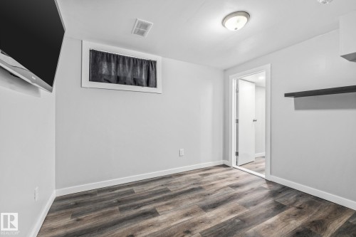 Recreation Room featuring dark wood-style floors and baseboards - 5911 119 Avenue, Edmonton, AB - Indoor Photo Showing Other Room