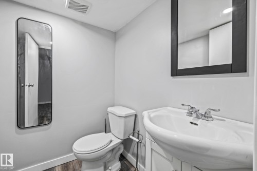 Bathroom featuring vanity and dark wood-style floors - 5911 119 Avenue, Edmonton, AB - Indoor Photo Showing Bathroom