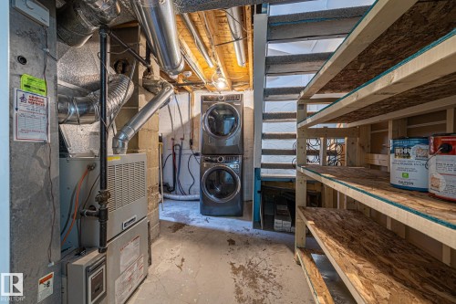 Laundry Room with heating unit and stacked washing machine and dryer - 5911 119 Avenue, Edmonton, AB - Indoor Photo Showing Laundry Room