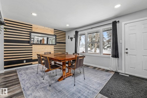 Dining area with an accent wall, recessed lighting, wood walls, and wood finished floors - 5911 119 Avenue, Edmonton, AB - Indoor