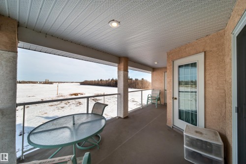View of snow covered back of property - 402 7803 Golf Course Road, Stony Plain, AB - Outdoor With Balcony With Exterior