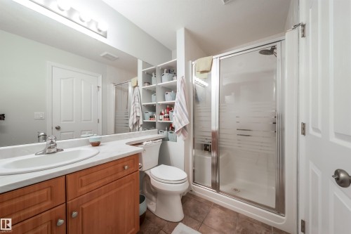 Bathroom featuring vanity, a stall shower, and dark tile patterned floors - 402 7803 Golf Course Road, Stony Plain, AB - Indoor Photo Showing Bathroom
