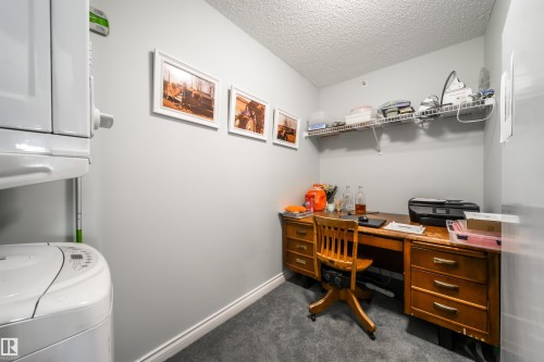Office area with washer / dryer, a textured ceiling, and dark carpet - 402 7803 Golf Course Road, Stony Plain, AB - Indoor