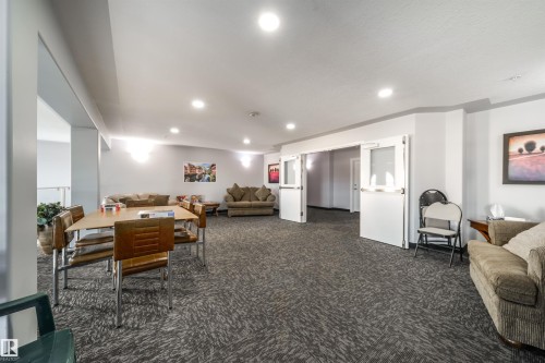 Living area featuring dark carpet and recessed lighting - 402 7803 Golf Course Road, Stony Plain, AB - Indoor