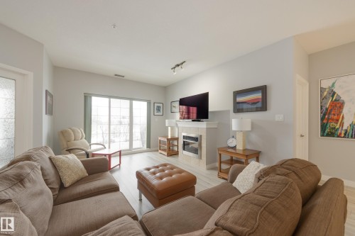 215 1003 Gault Boulevard, Edmonton, AB - Indoor Photo Showing Living Room With Fireplace
