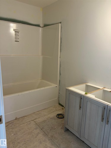 Bathroom featuring vanity and a tub to relax in - 8923 Elves Loop, Edmonton, AB - Indoor Photo Showing Bathroom