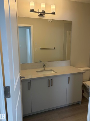Bathroom featuring vanity and light wood-style floors - 5756 Hawthorn Common, Edmonton, AB - Indoor Photo Showing Bathroom