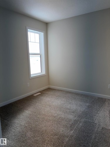 Carpeted spare room featuring baseboards - 5756 Hawthorn Common, Edmonton, AB - Indoor Photo Showing Other Room