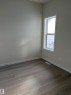 Spare room featuring baseboards and light wood-style flooring - 5756 Hawthorn Common, Edmonton, AB  - Indoor Photo Showing Other Room 